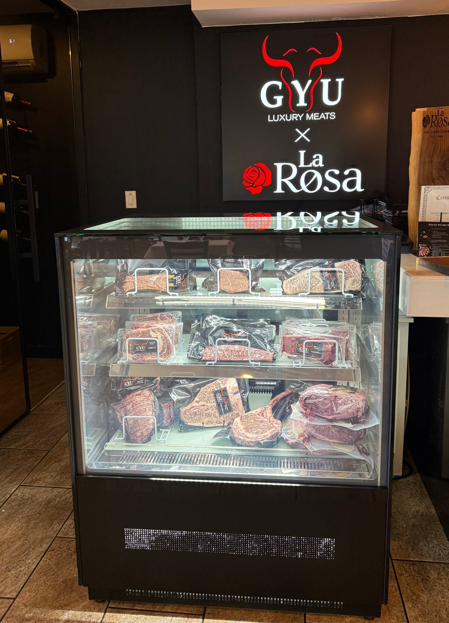Display case with sliced meats in a restaurant setting, featuring 'GYU' and 'La Rosa' branding.